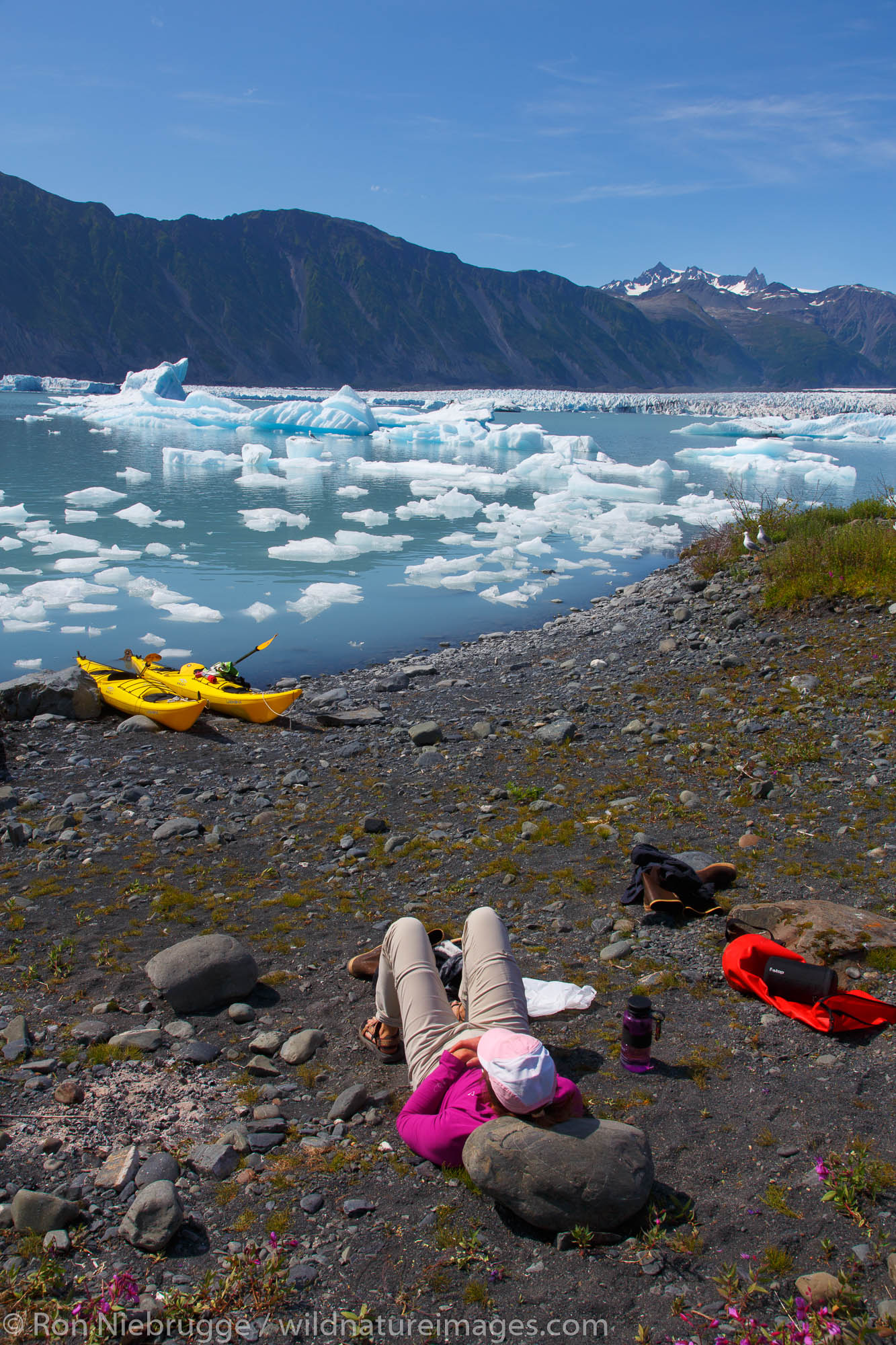 Kayaking in Bear Glacier Lagoon, Kenai Fjords National Park, near Seward, Alaska.  (model released)