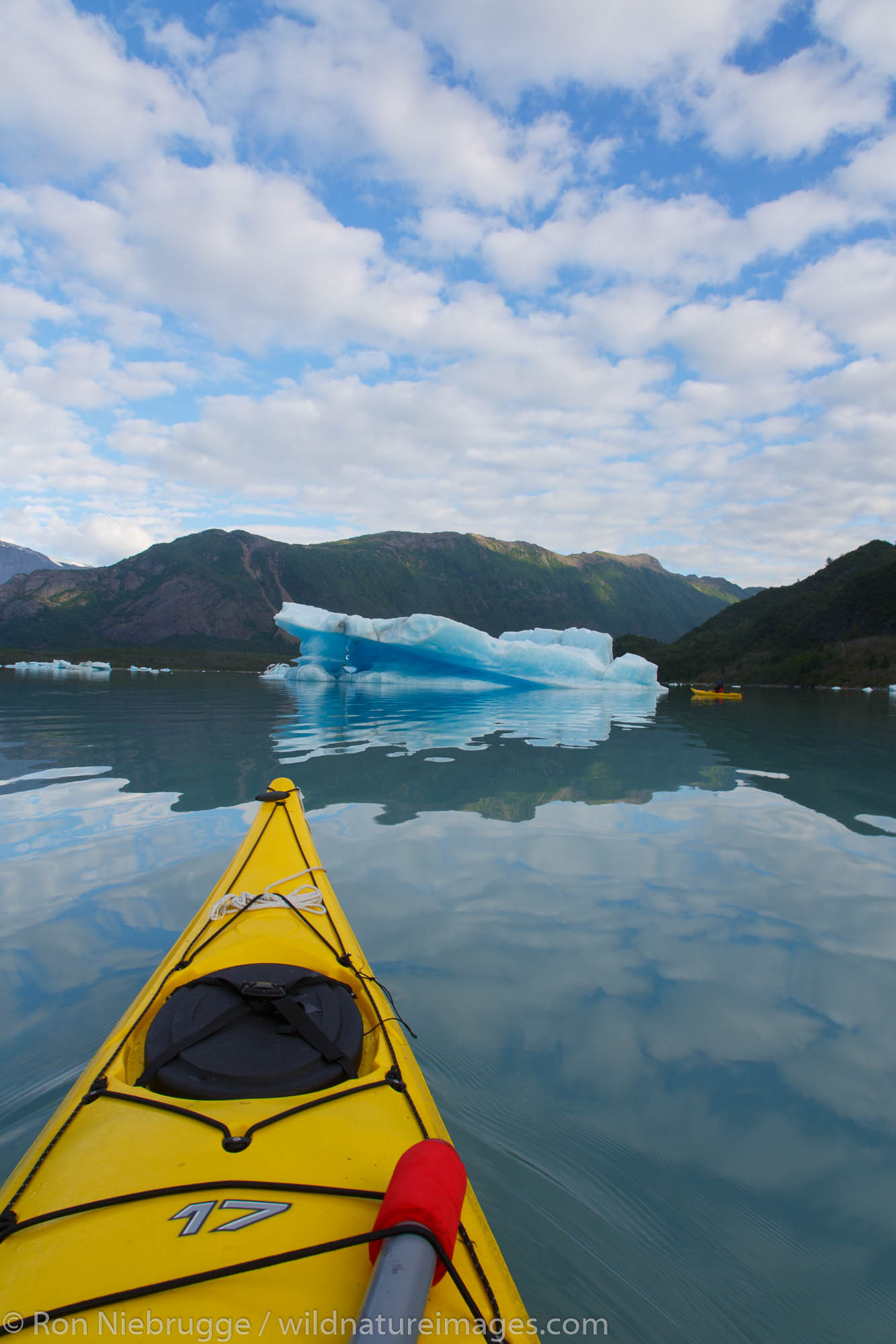 Kayaking in Bear Glacier Lagoon, Kenai Fjords National Park, near Seward, Alaska.  (model released)