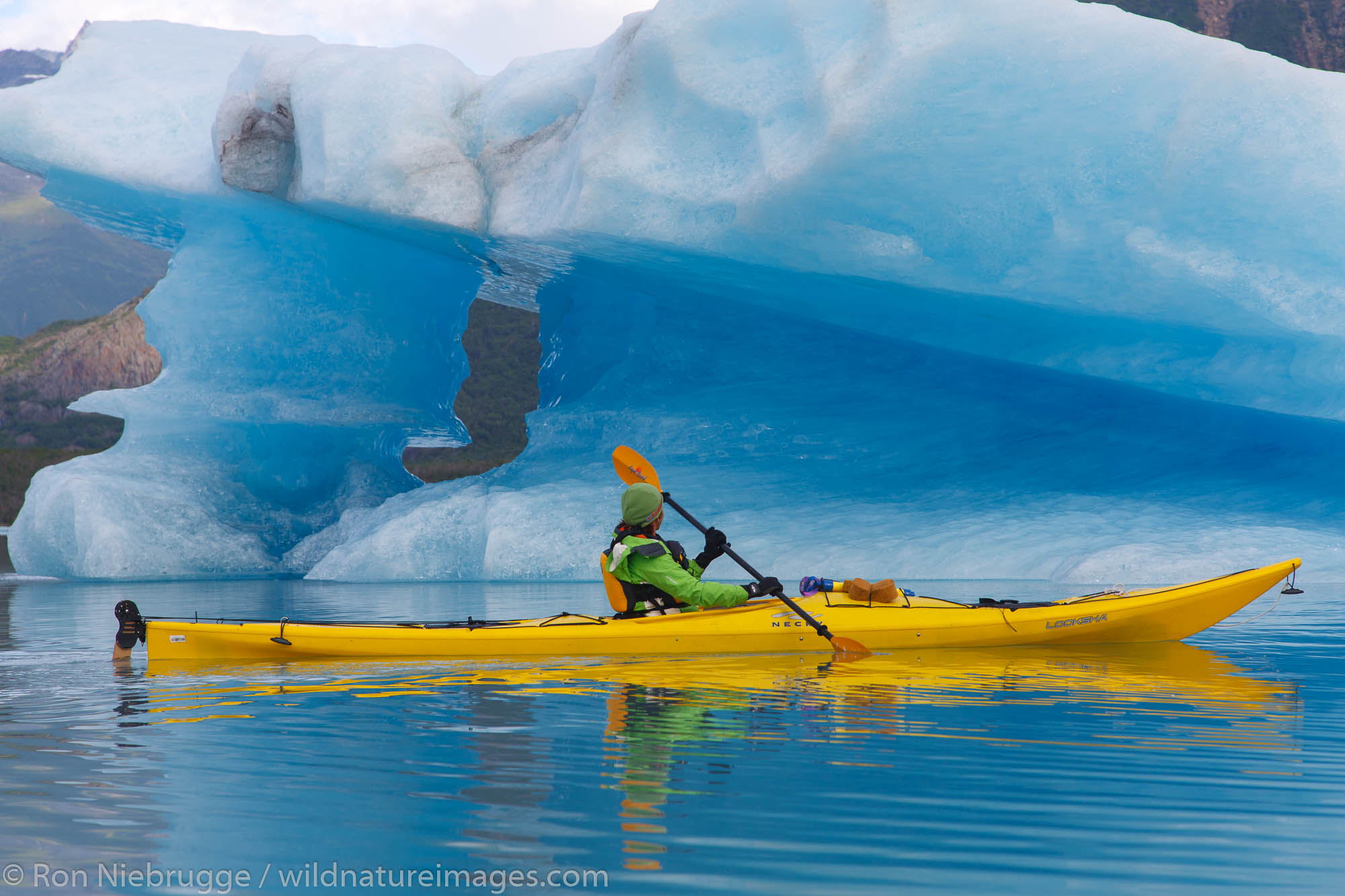 Kayaking in Bear Glacier Lagoon, Kenai Fjords National Park, near Seward, Alaska.  (model released)