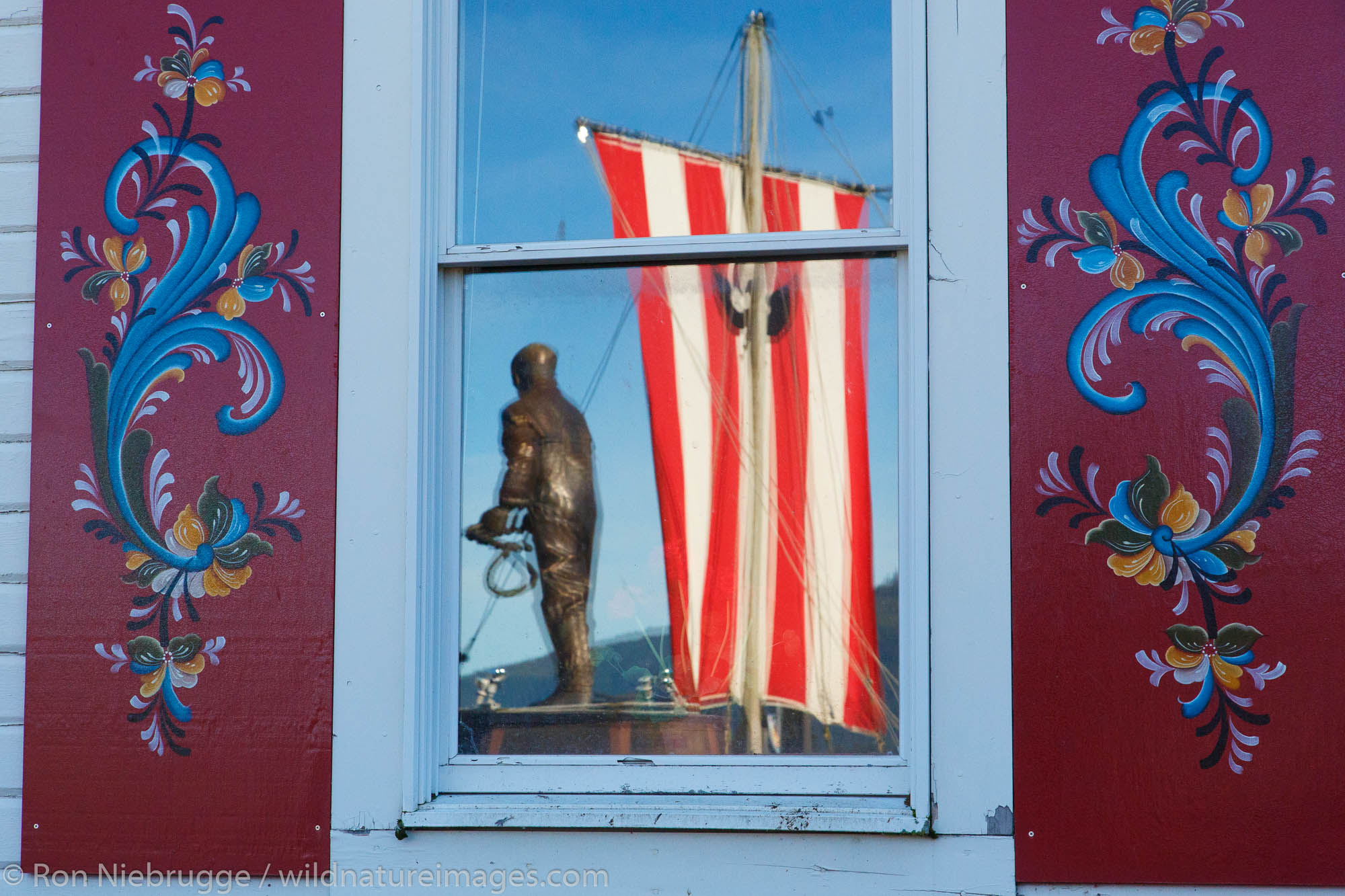 Fisherman's Memorial Park reflected in the windows of the Sons of Norway Hall, Petersburg, Alaska.