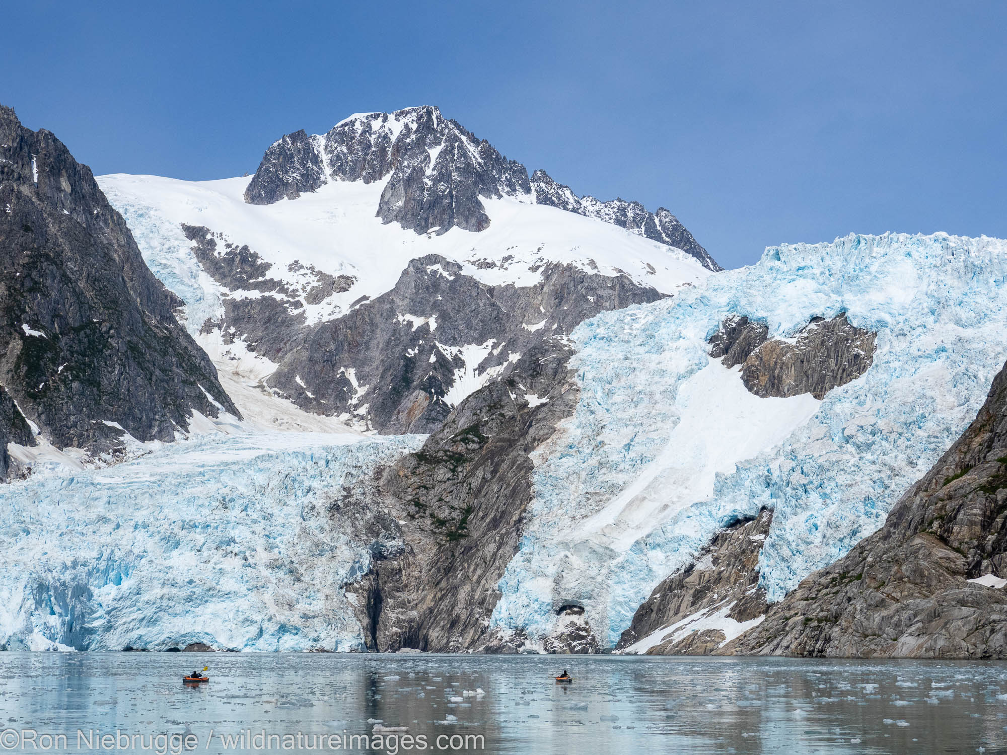 Kayaking in front of Northwestern Glacier in Northwestern Fjord, Kenai Fjords National Park, near Seward, Alaska.