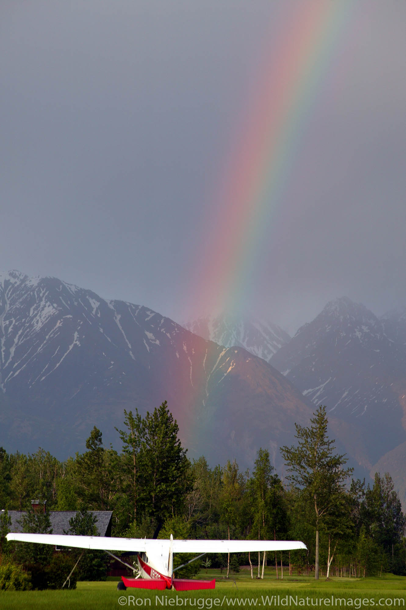 Cessna 180 with Rainbow Rainbow over Cessna 180. Skyview Ranch, Palmer, Alaska.