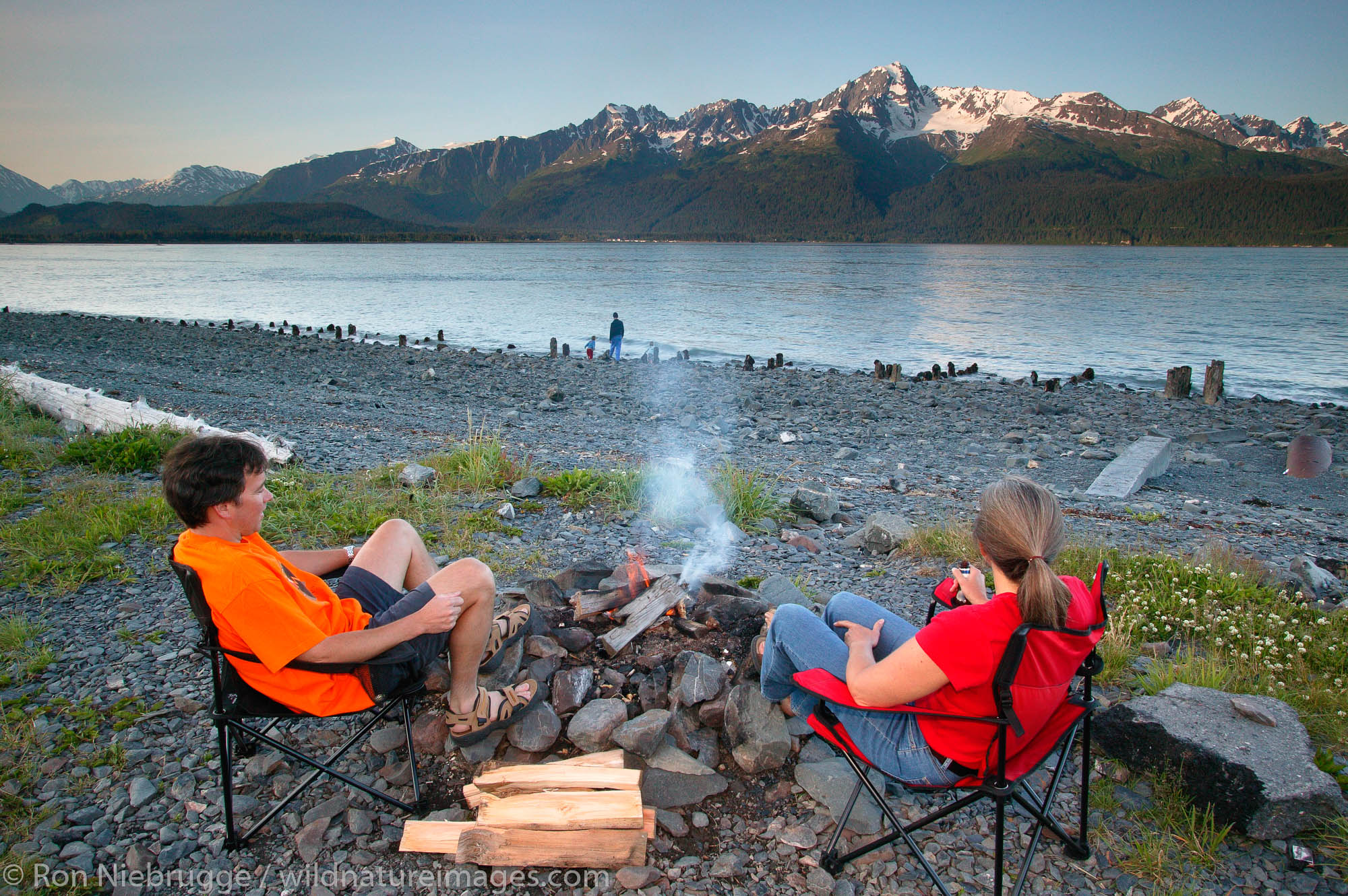 Campers enjoying campfire on the shores of Resurrection Bay. Seward,  Alaska.  MR