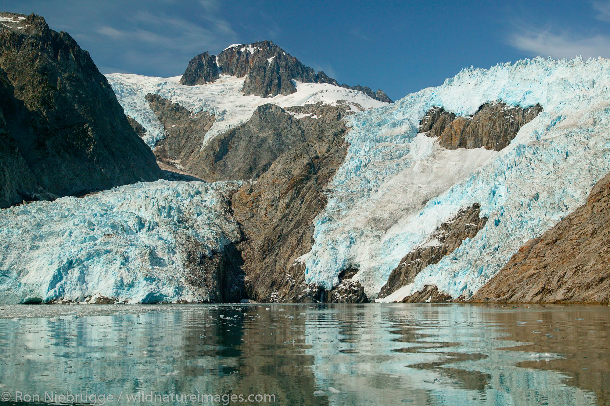Kayakers in front of Northwestern Glacier, in Northwestern Fjord, Kenai Fjords National Park, Alaska.