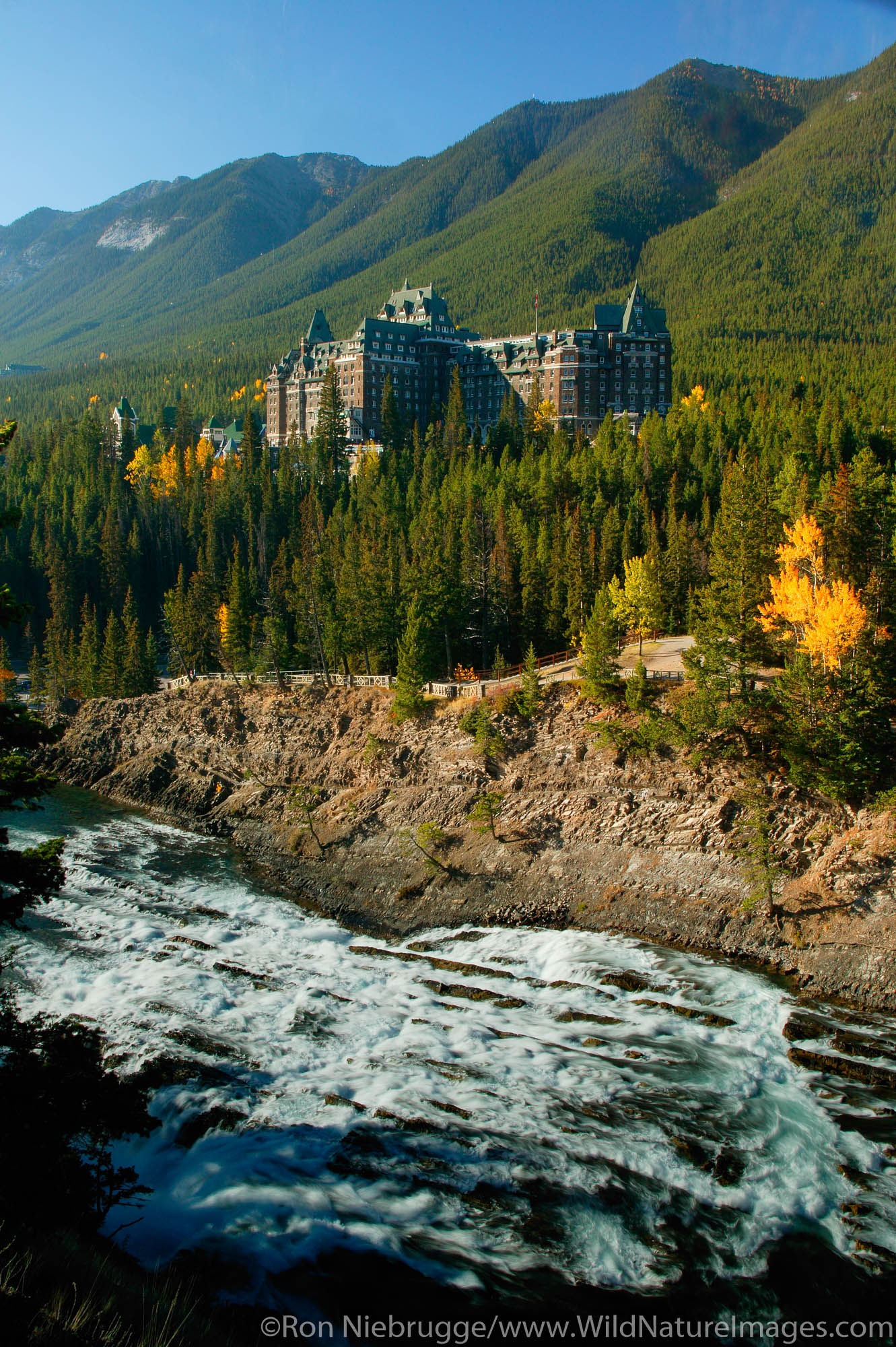 Banff Springs Hotel and the Bow River at the Bow Falls, Banff, Banff National Park, Alberta, Canada.